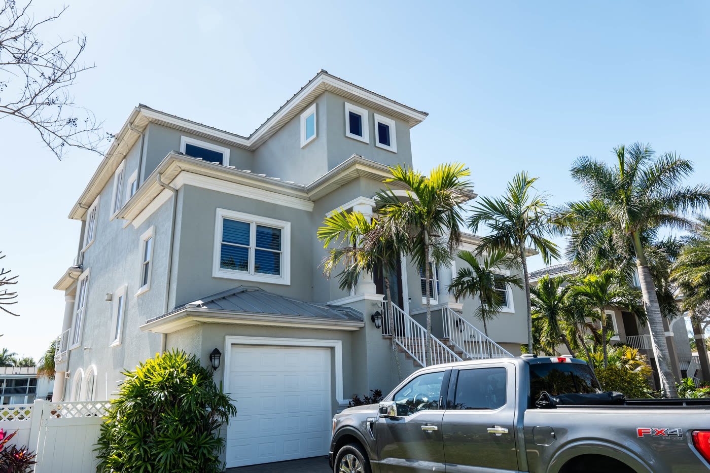 Elevated gray coastal Florida home exterior painted by LIME Painting